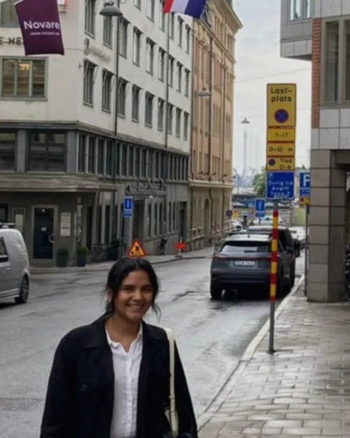 Mujer frente al consulado de Croacia con la bandera croata al fondo